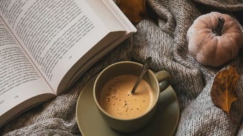 Coffee and a book on a cozy blanket