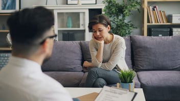 Couple in conversation on a therapy couch
