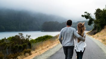 Couple walking together down a quiet road