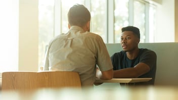 Two men in an open, friendly conversation