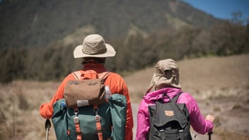 Couple with backpacks out hiking together