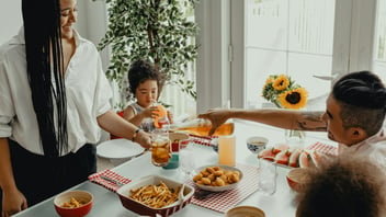 Mother and daughter together in the kitchen in the morning