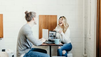 Two people in easy conversation at a table