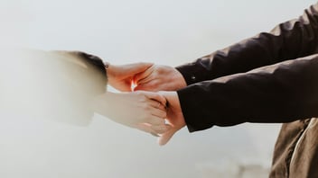 Couple holding hands side by side