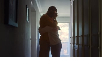 Couple embracing in the hallway of their home