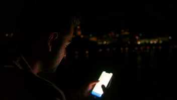 Teen texting on his phone