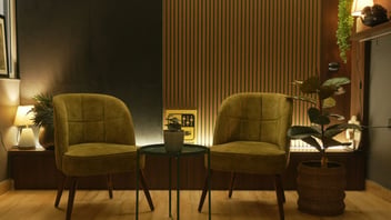 Cozy lounge with two green armchairs