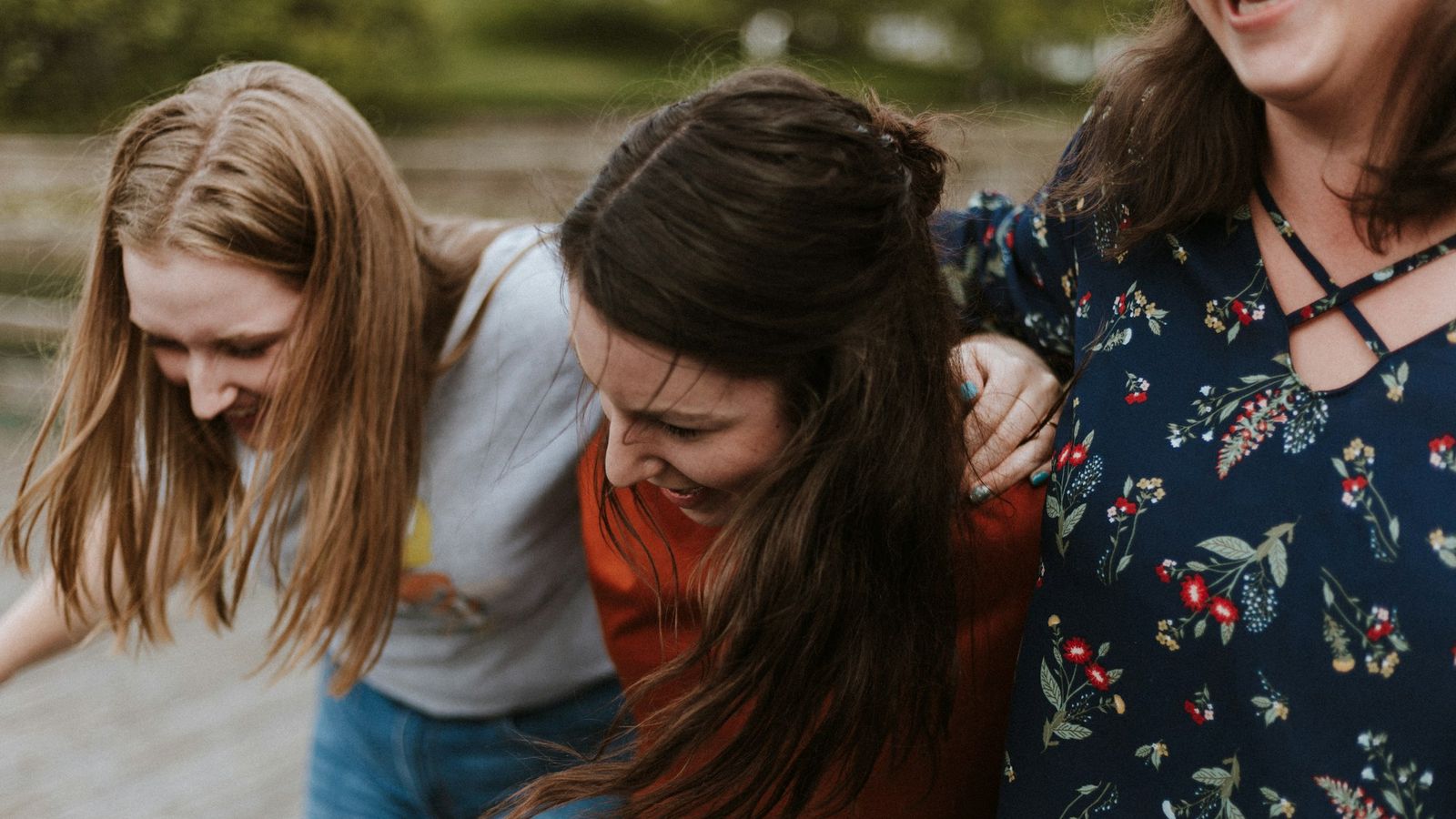 Three teen friends smiling together