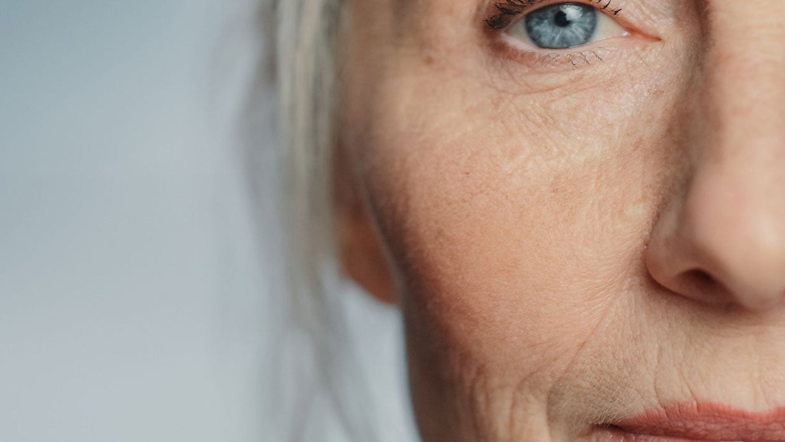 Close up of an older woman's face as she looks thoughtfully toward the light