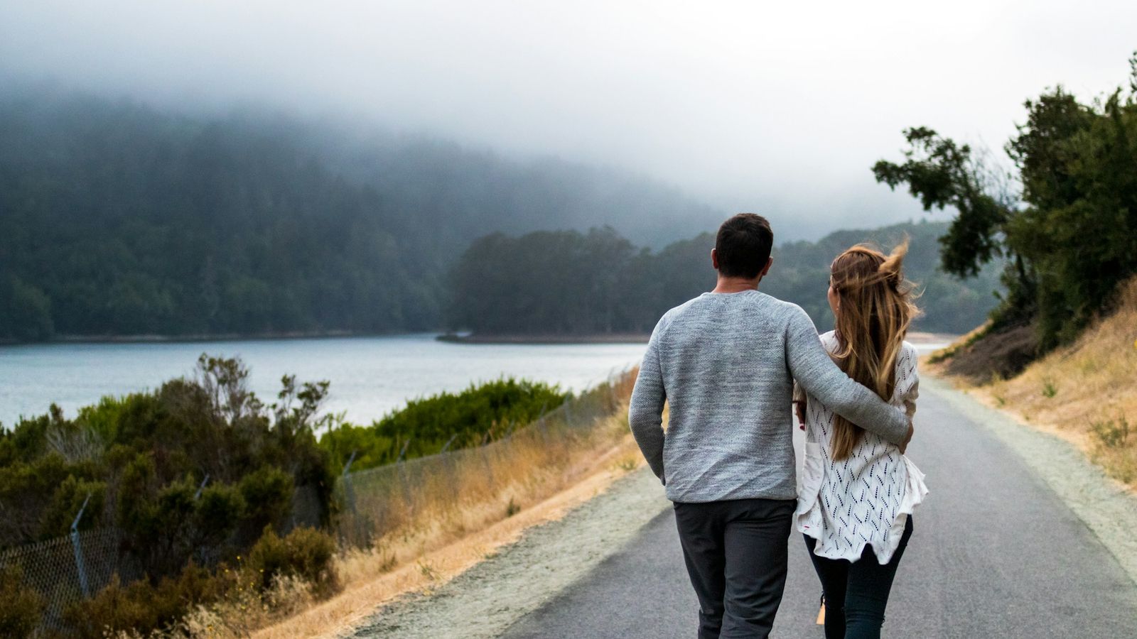 Couple walking together down a quiet road