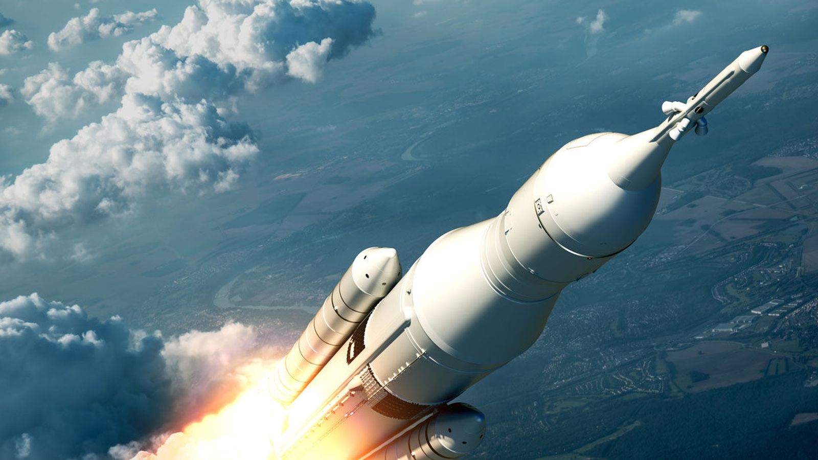 Rocket lifting off through the clouds high above the ground