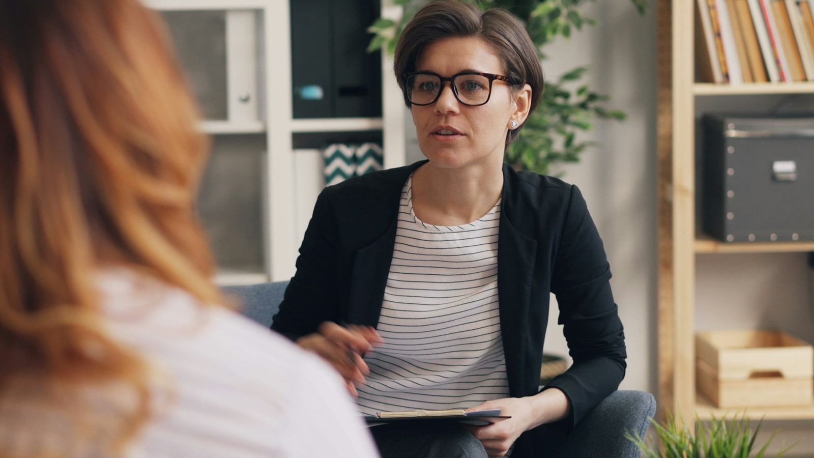 Two women talking together on a couch