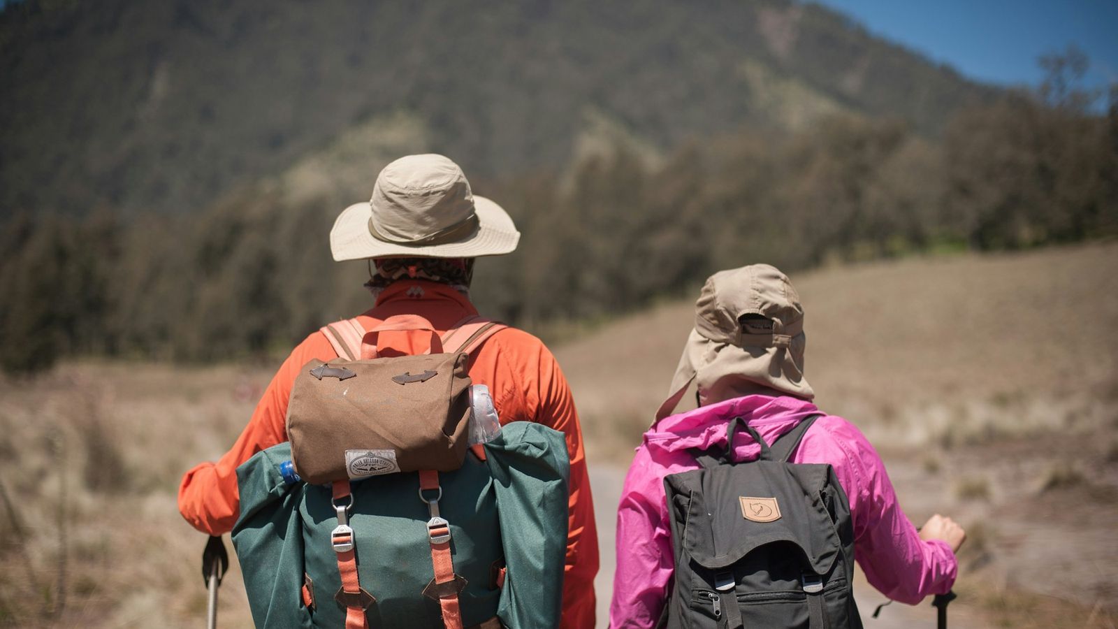 Couple with backpacks out hiking together