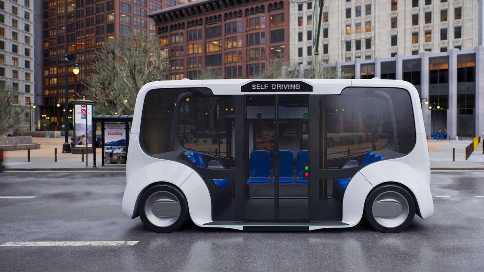 Small self driving shuttle bus traveling down a city street