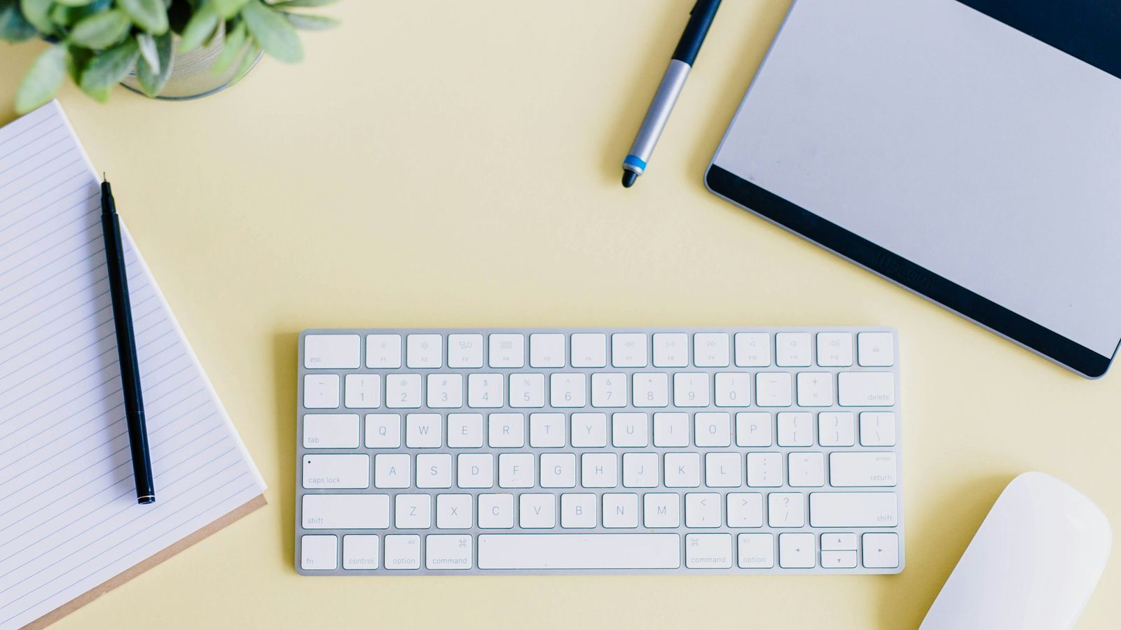 Neatly organized desk with keyboard and notepad