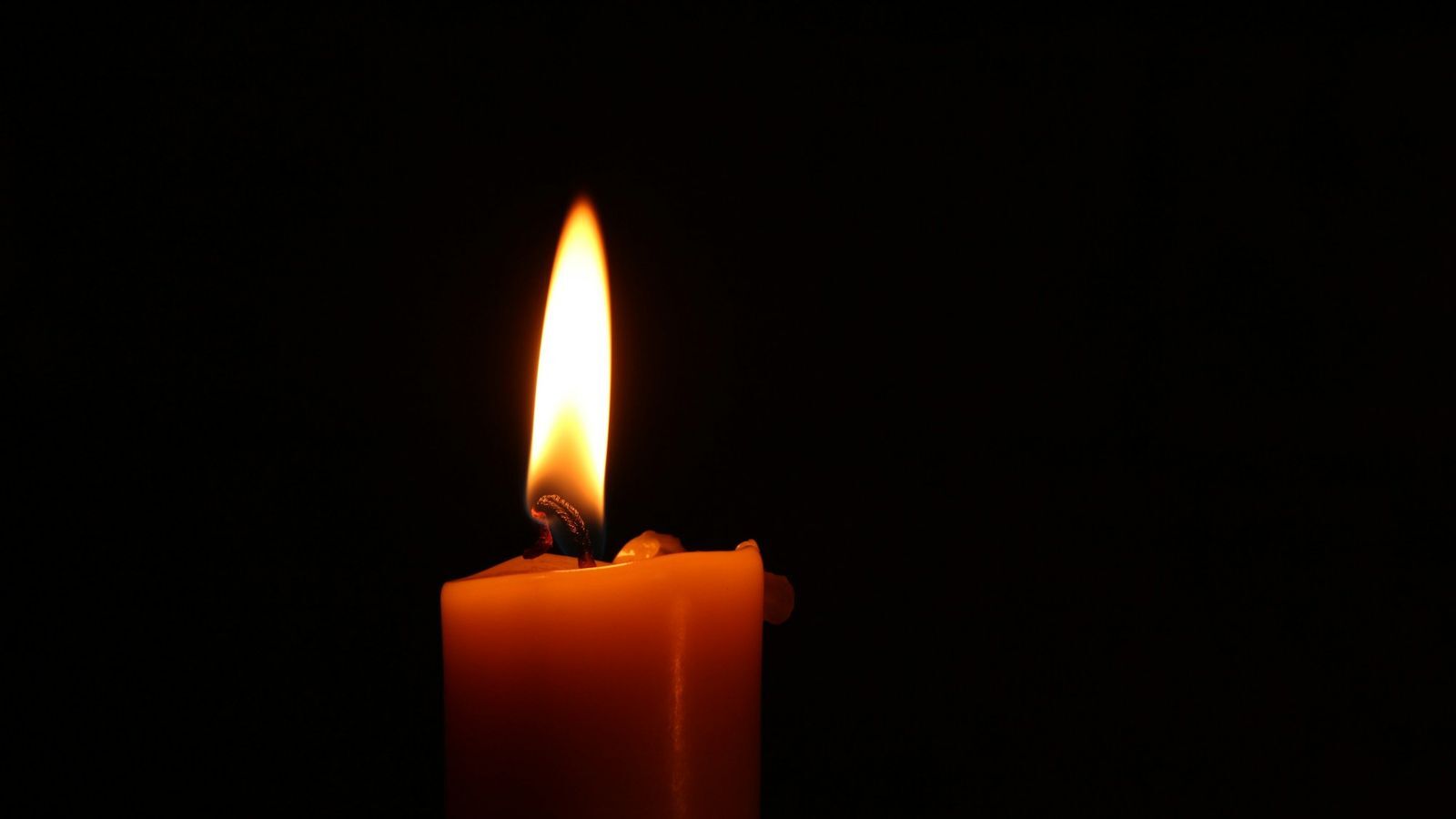 Quiet candle flame in the dark
