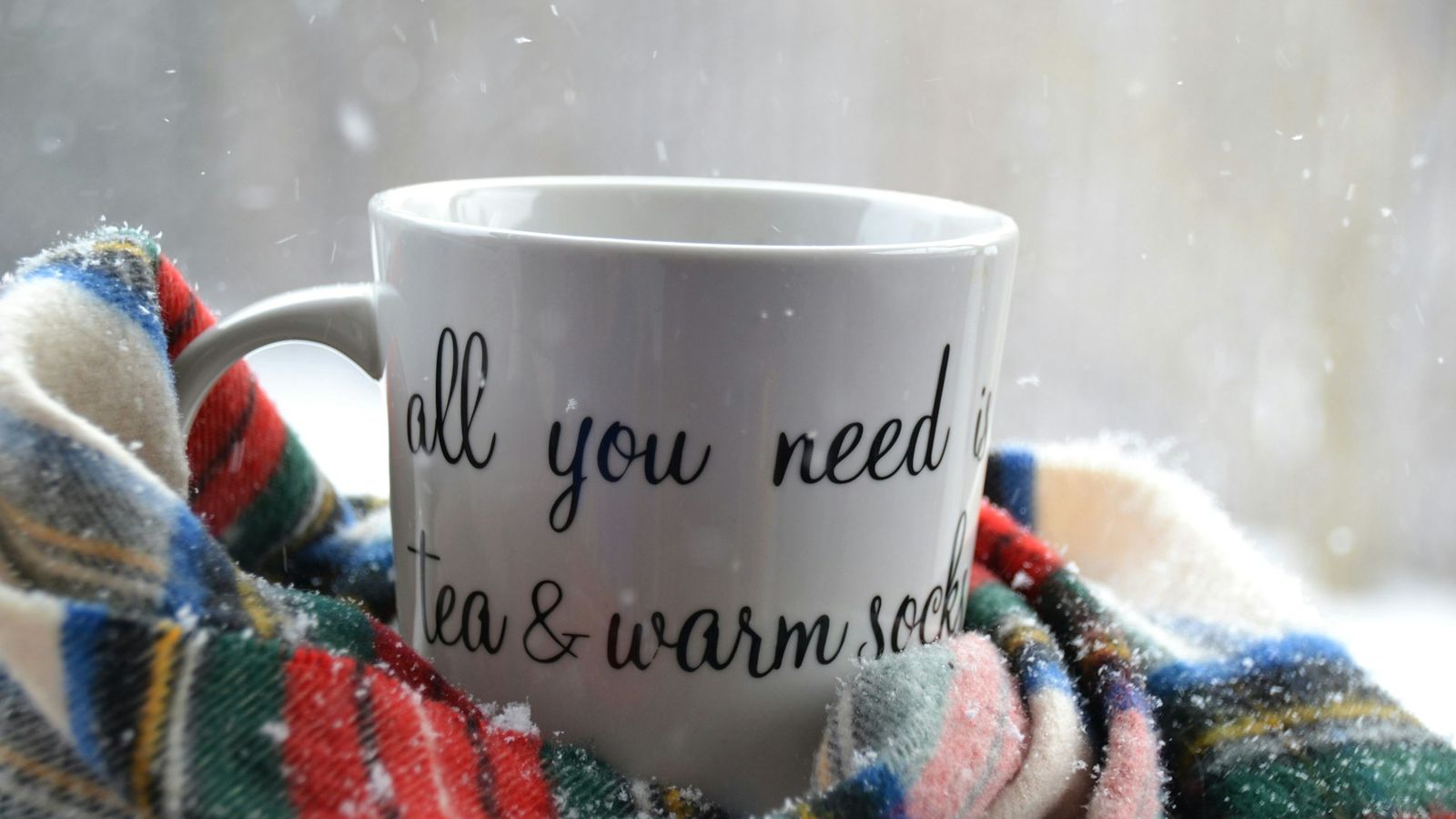 warm tea and cozy socks on a snowy winter day