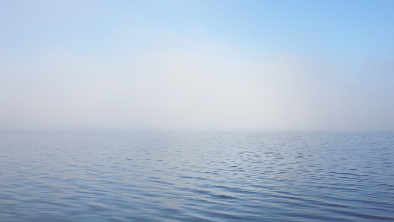 Calm blue ocean under soft light