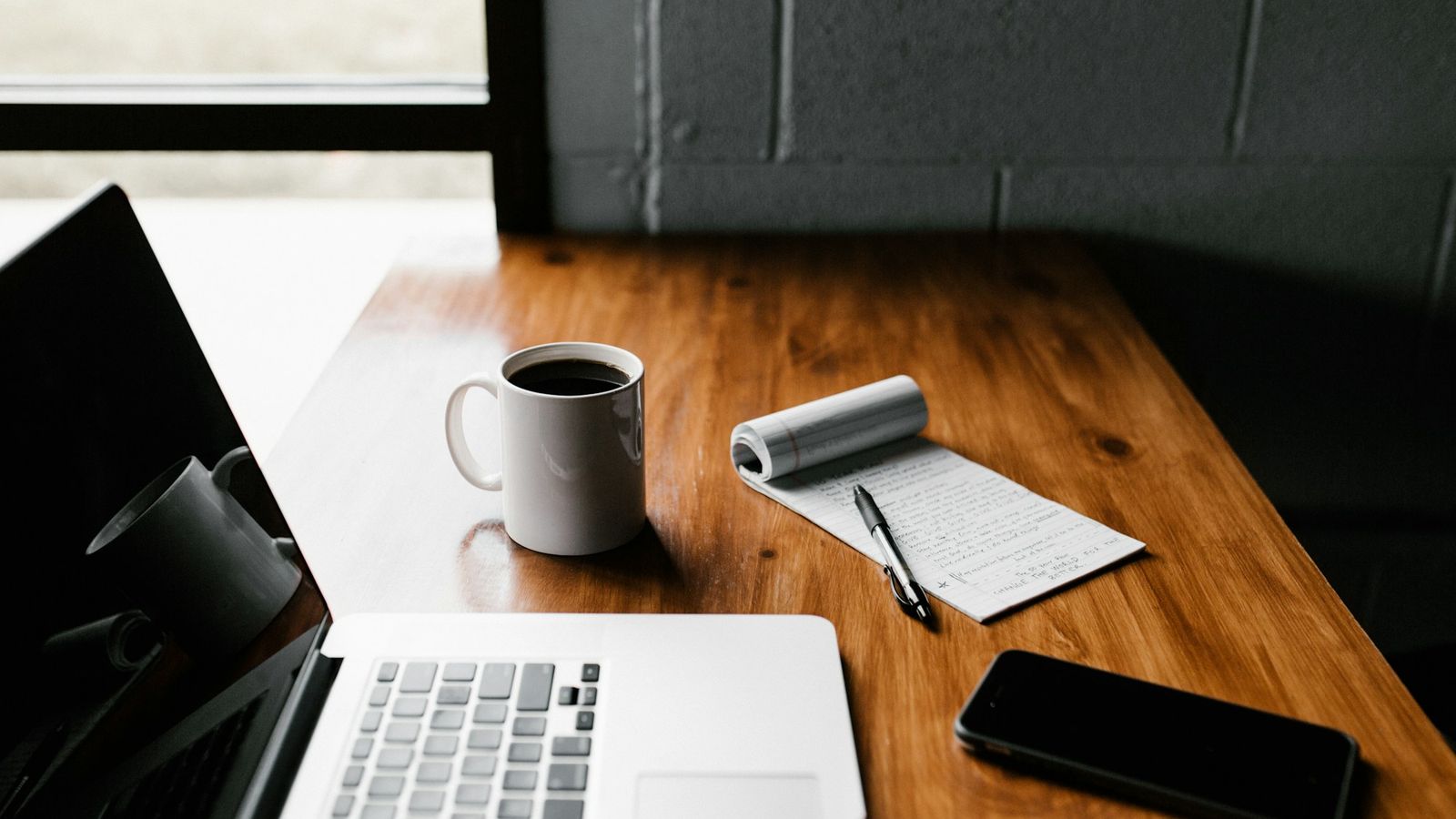 Laptop and coffee mug on a work desk