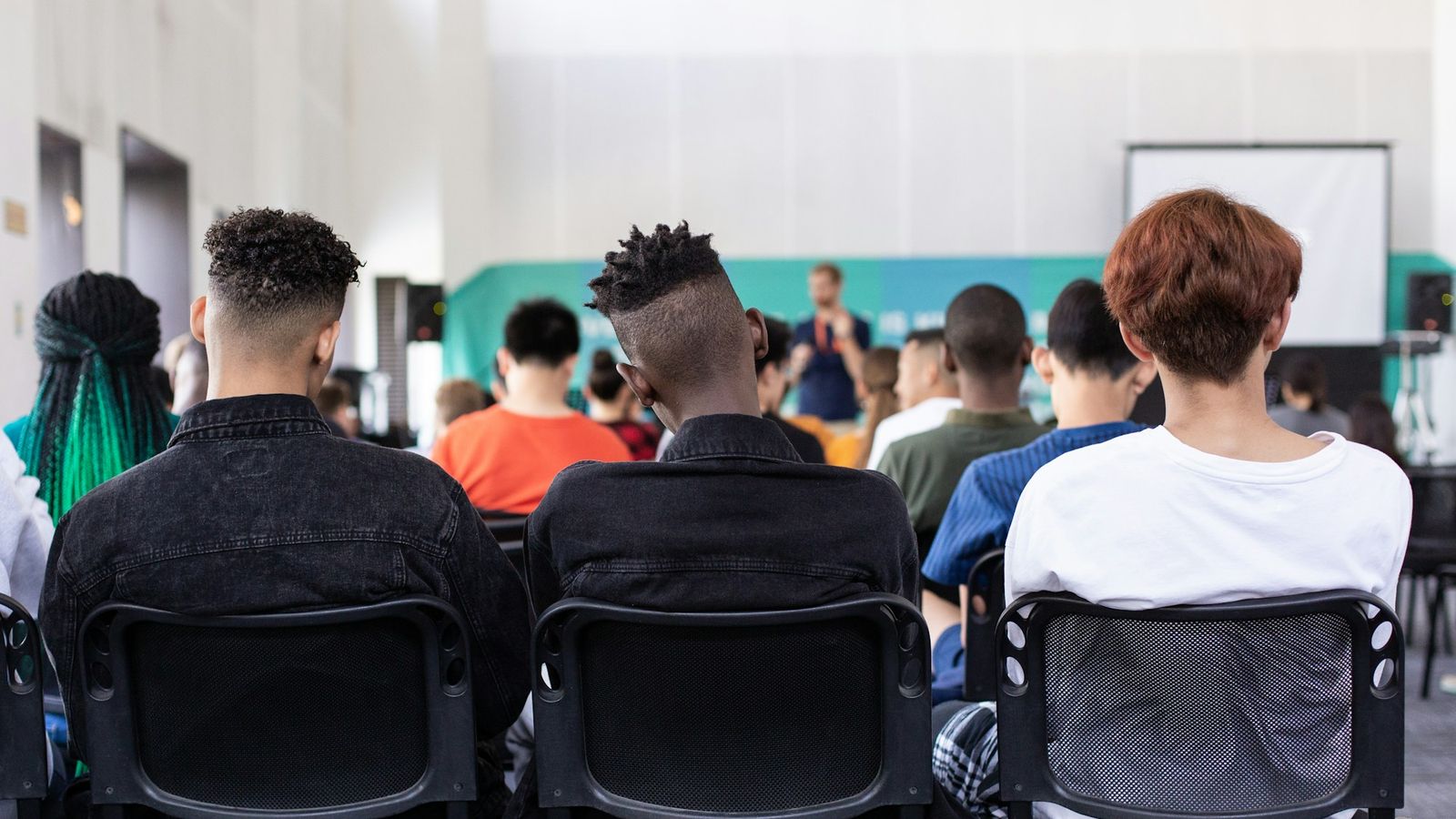 High school students seated in a classroom, seen from behind