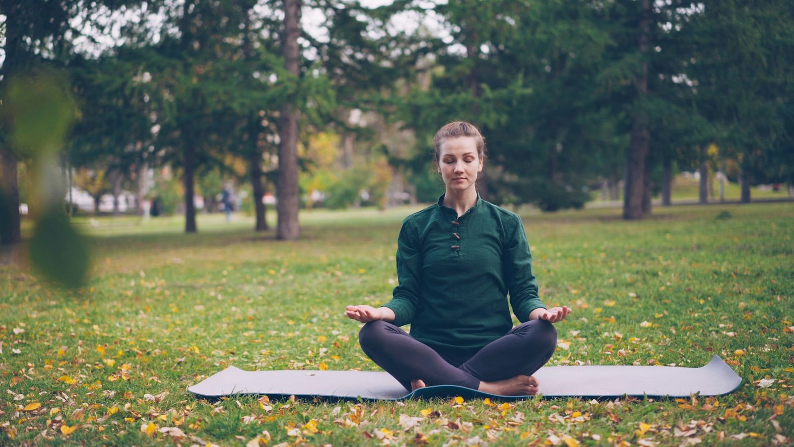 Woman meditating peacefully in a park
