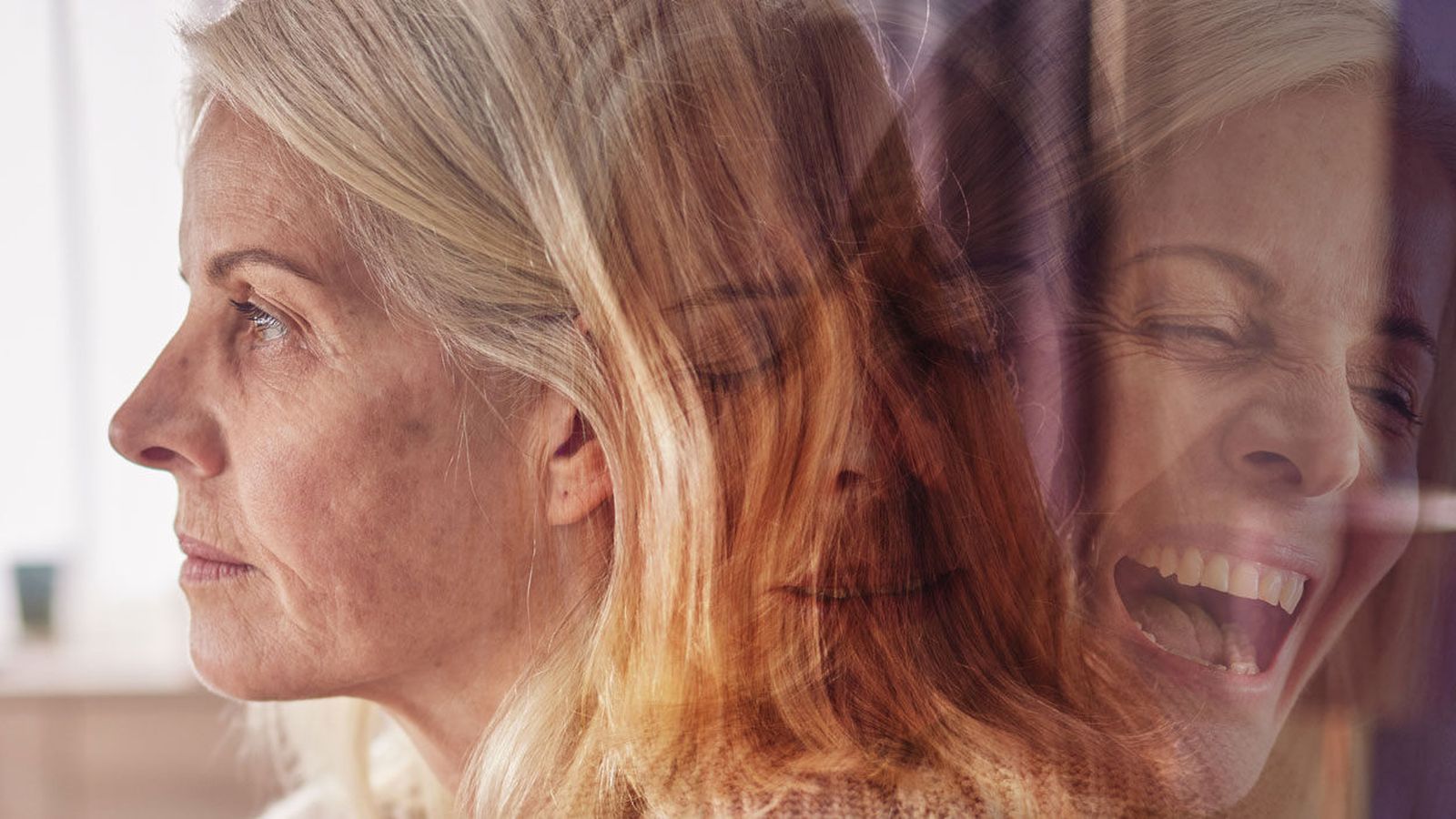 A double exposure portrait of a woman shown both downcast and laughing