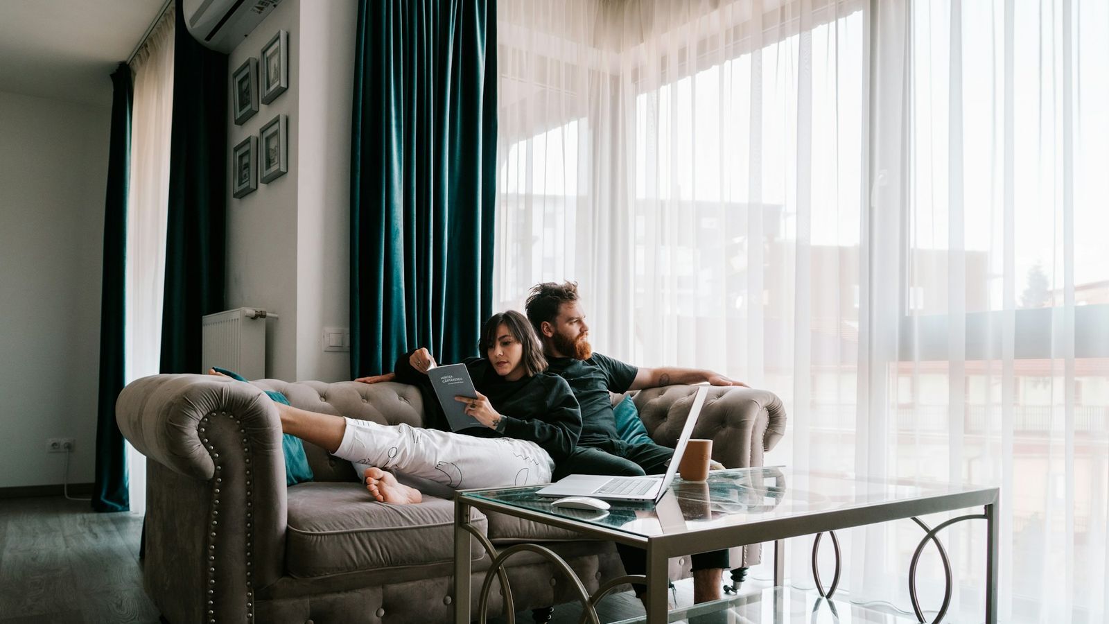 Couple relaxing together on a couch at home in a bright living room