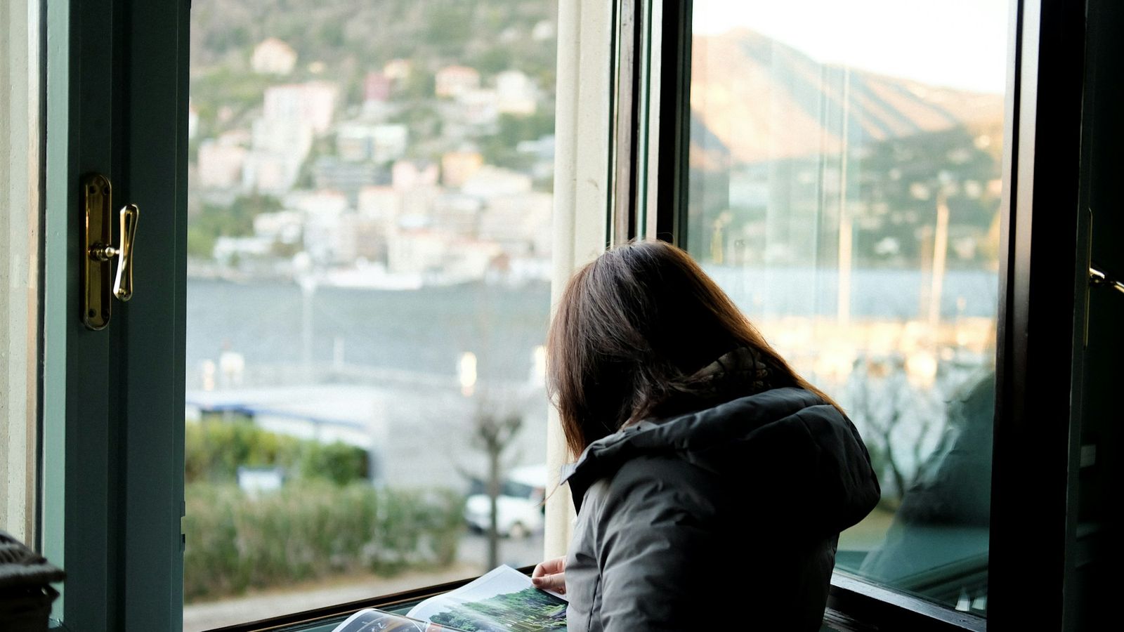Woman thinking quietly by a bright window