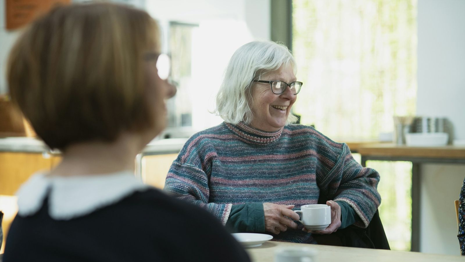 Quiet, supportive conversation over coffee