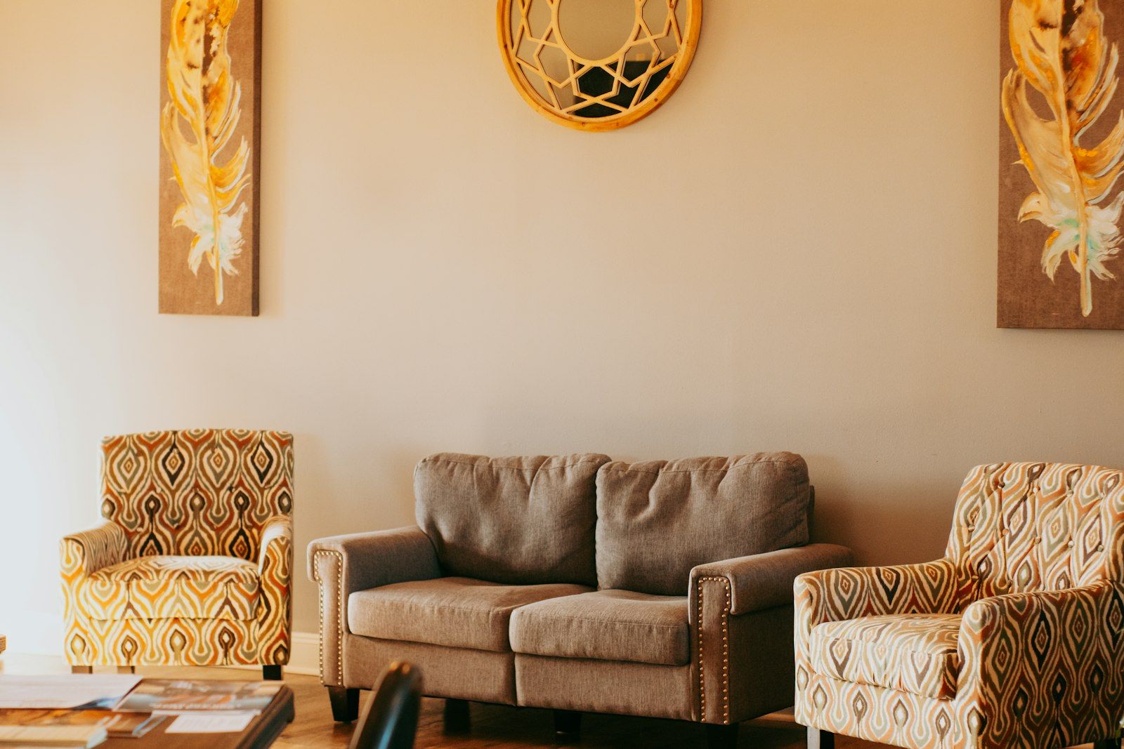 Warm and inviting counseling office sitting room with a couch and armchairs