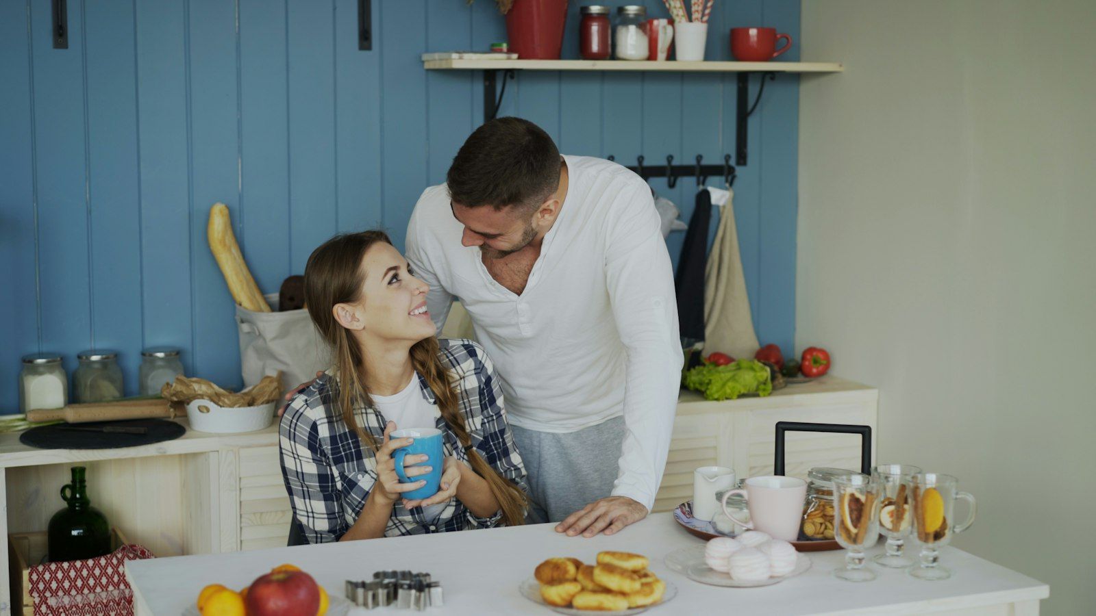 Couple talking together at their kitchen table in the morning