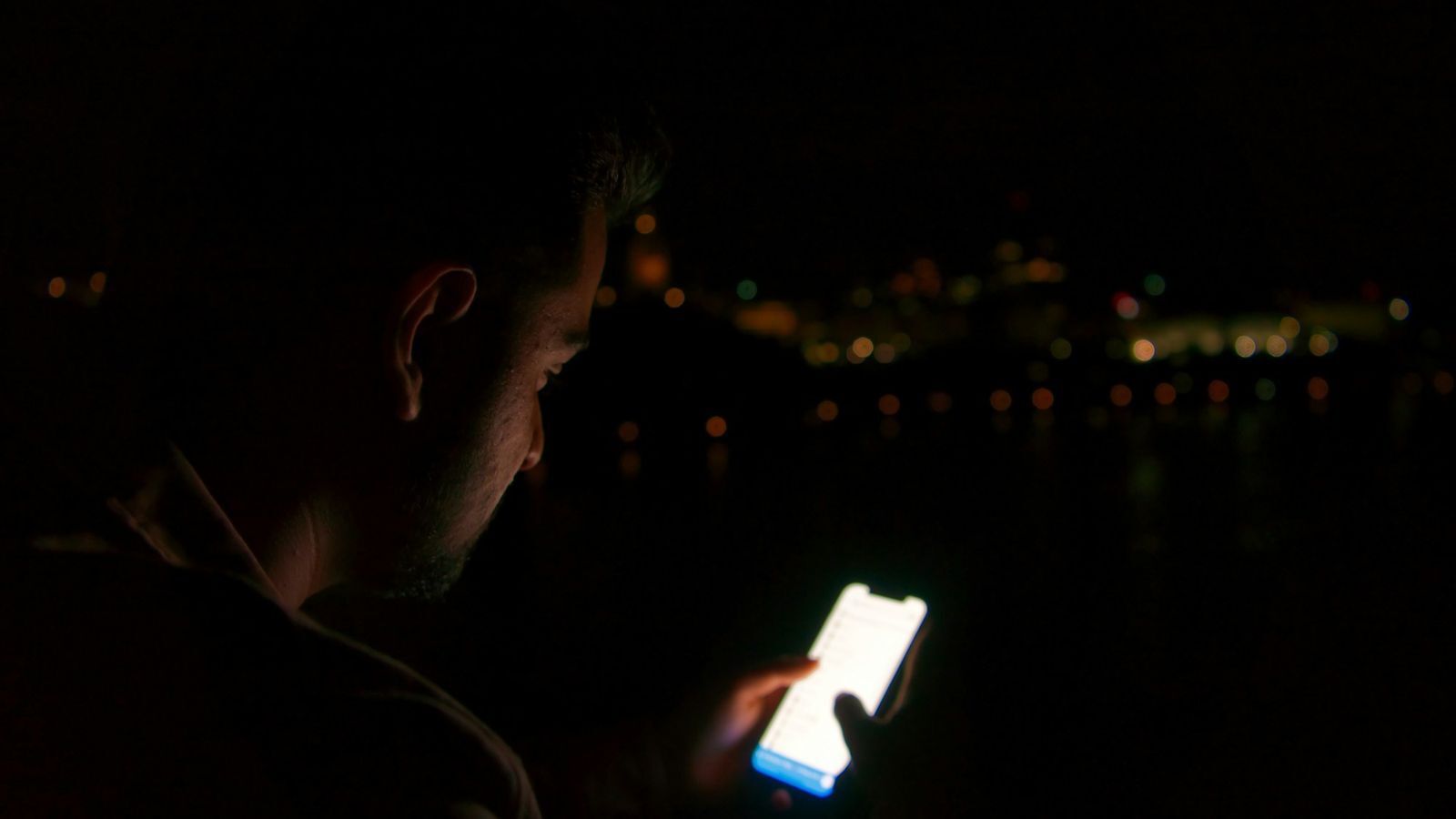 Teen texting on his phone