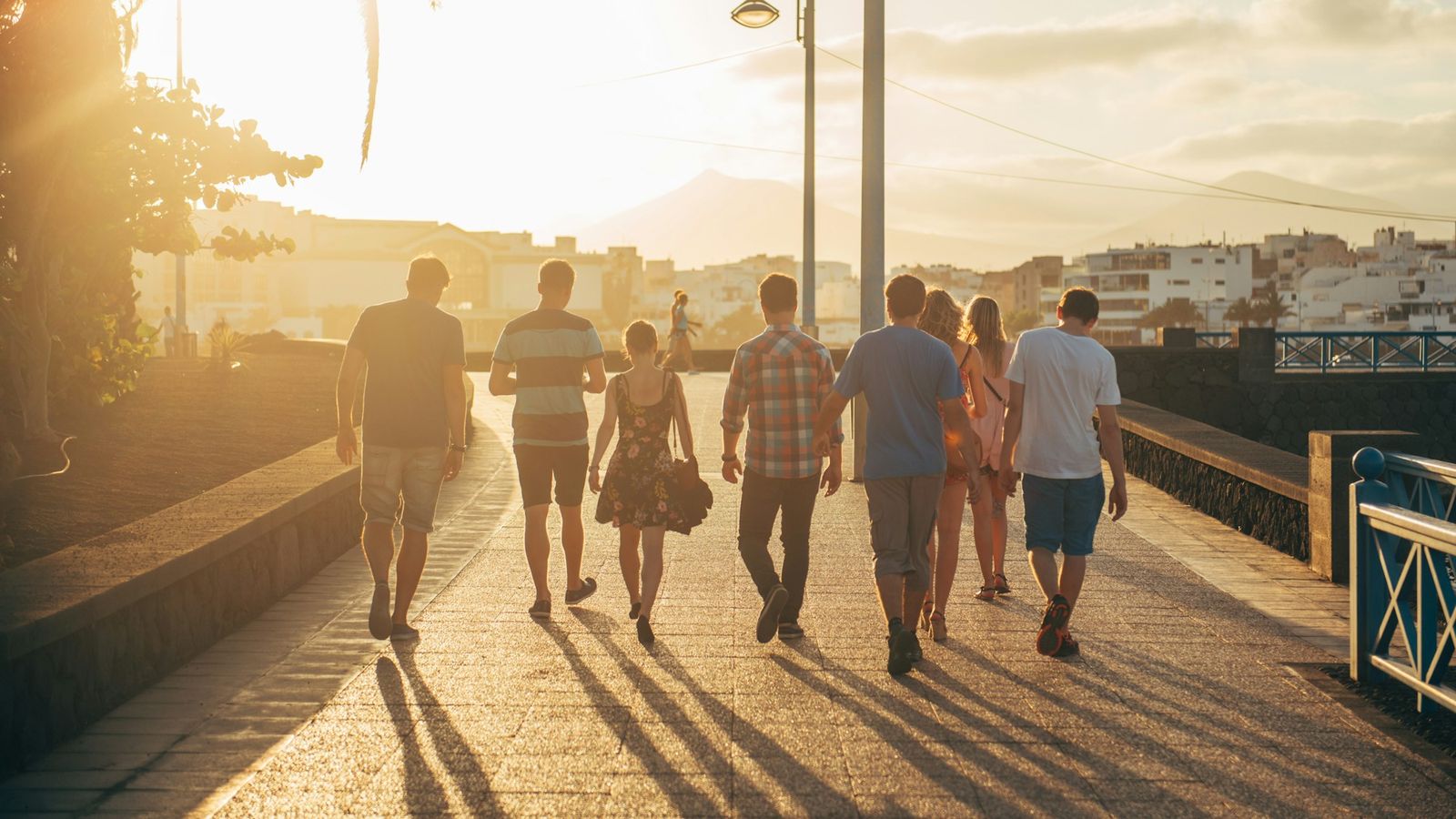 people walking together on sand in warm light