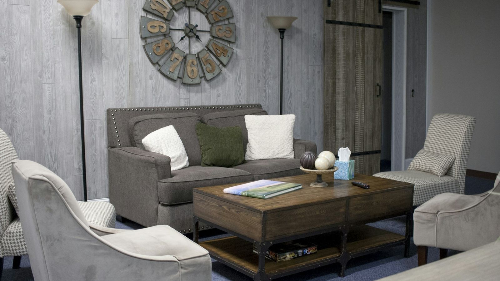 A calm counseling office with a gray sofa and two armchairs
