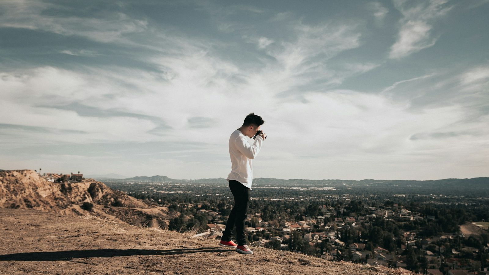 a person standing confidently on a mountain overlook
