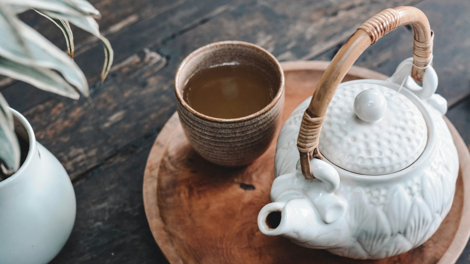 a ceramic teapot and cup on a wooden tray, a quiet tea ritual