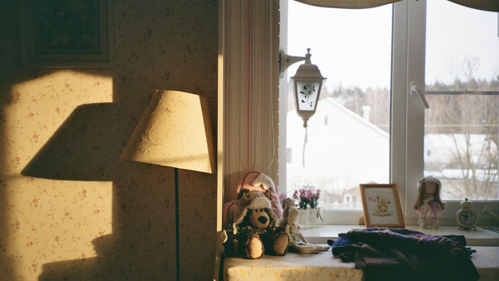 Warm sunlight filling a cozy room with a snowy winter view through the window