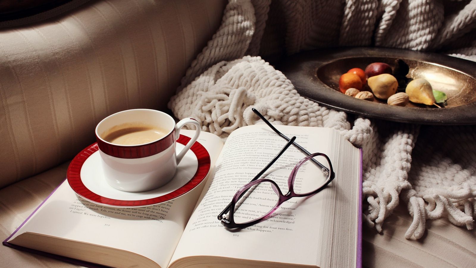 Open book with coffee and reading glasses